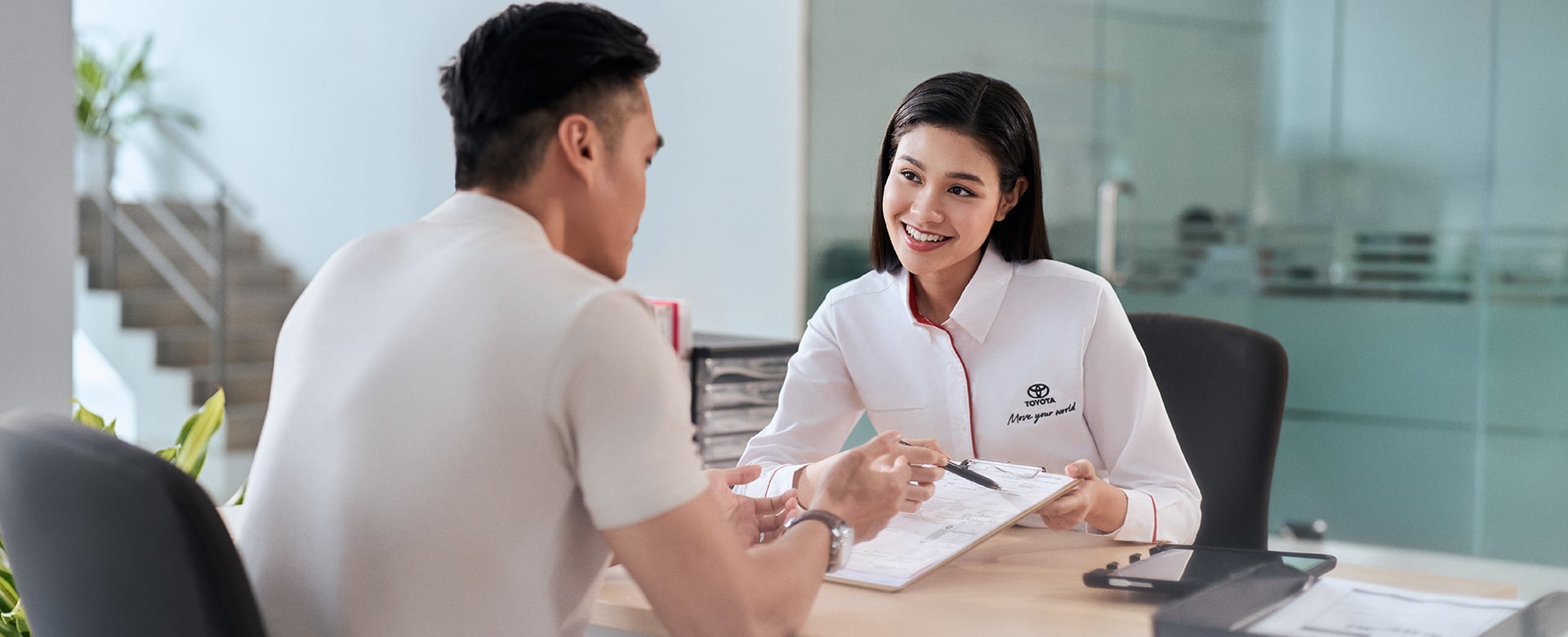 Toyota consultant assisting a customer with insurance