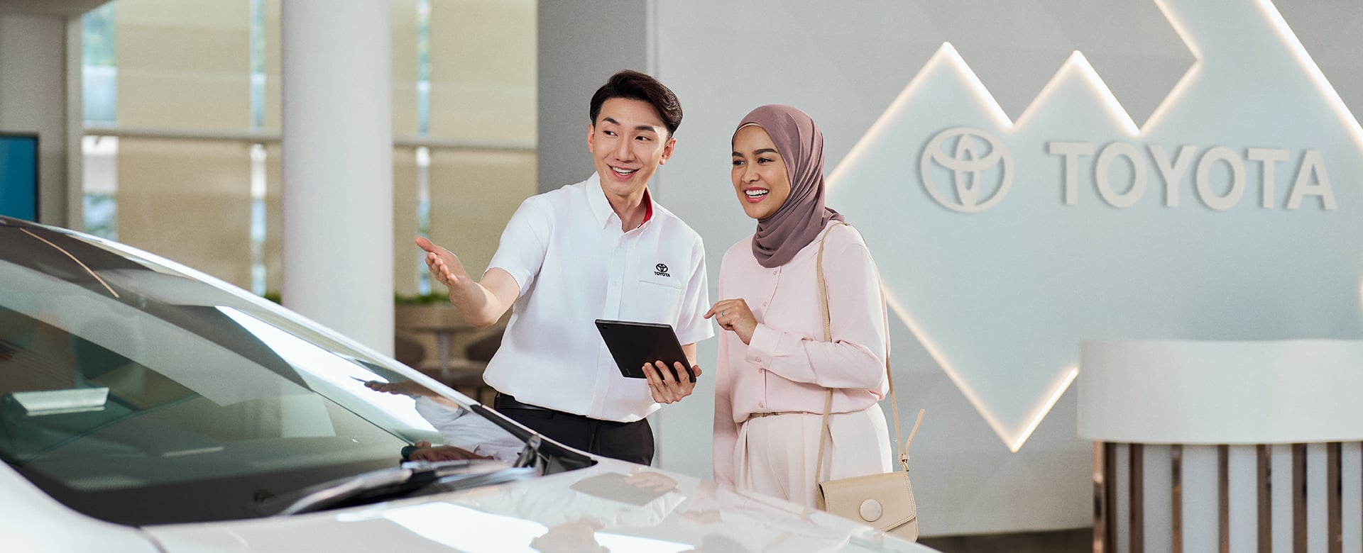 Toyota showroom consultant assisting a customer with financing information